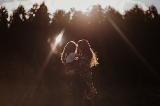 Mother holding child outside