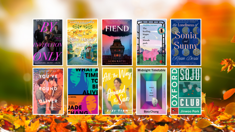 A collage of September 2025 book releases displayed against an autumn-themed background with orange leaves and a soft golden sunset glow. The book covers shown are: "By Invitation Only" by Alexandra Brown Chang, "The Nine Moons of Han Yu and Luli" by Karina Yan Glaser, "Fiend" by Alma Katsu, "The Healing Hippo of Hinode Park" by Michiko Aoyama, "The Loneliness of Sonia and Sunny" by Kiran Desai, "You’ve Found Oliver" by Dustin Thao, "What a Time to Be Alive" by Jade Chang, "All the Way Around the Sun" by XiXi Tian, "Midnight Timetable" by Bora Chung, and "Oxford Soju Club" by Jinwoo Park.